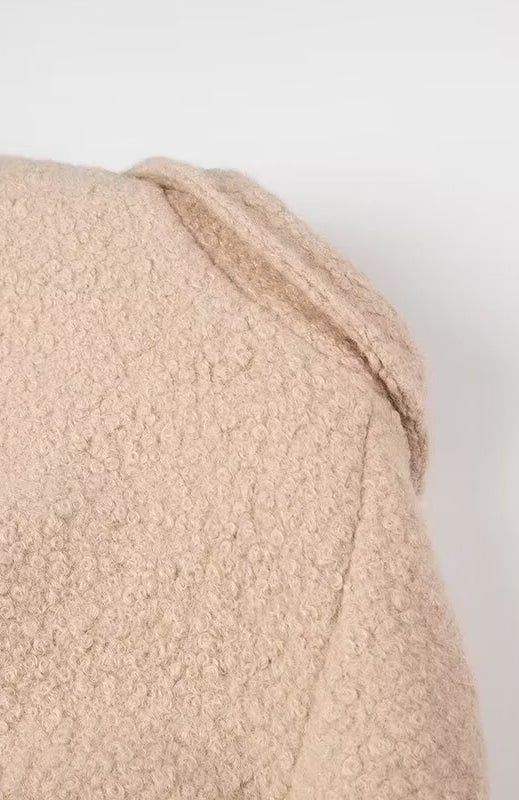 Beige textured bath towel with folded corner in Langry double breasted fashion overcoat