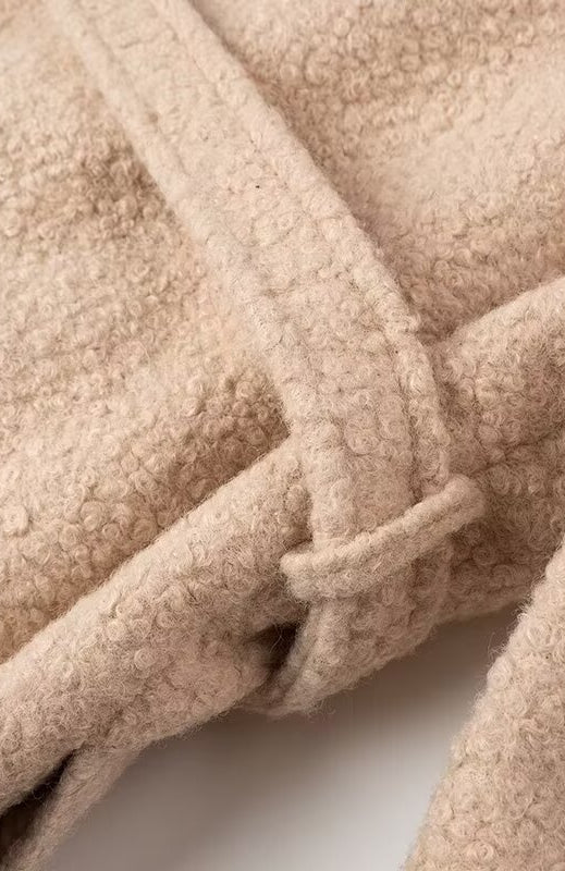 Beige sherpa double breasted overcoat with textured surface