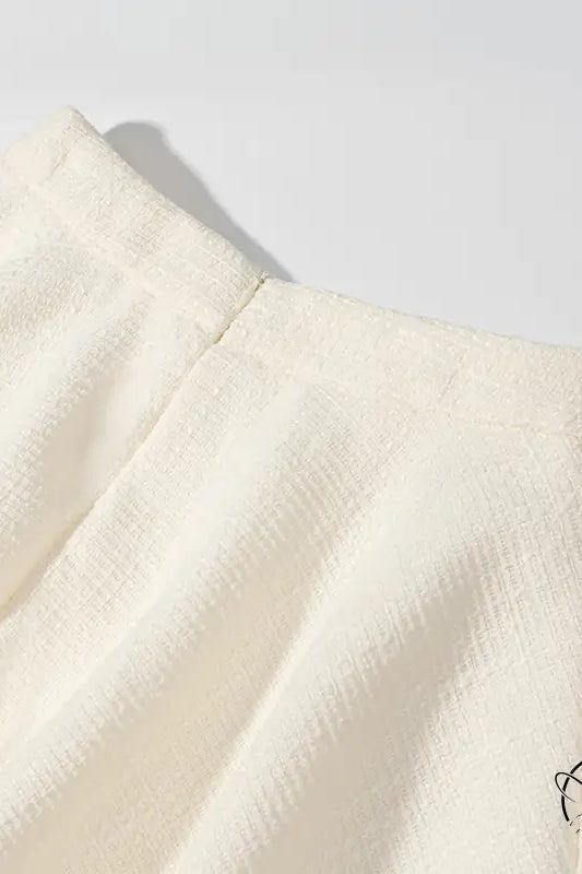 Enchanting short sleeve bud top with cream pleated skirt