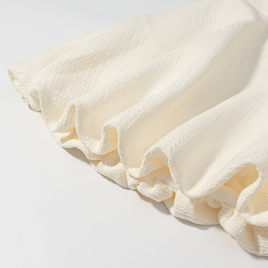 Cream ruffled skirt with textured weave in Enchanting Short Sleeve Bud Top suit