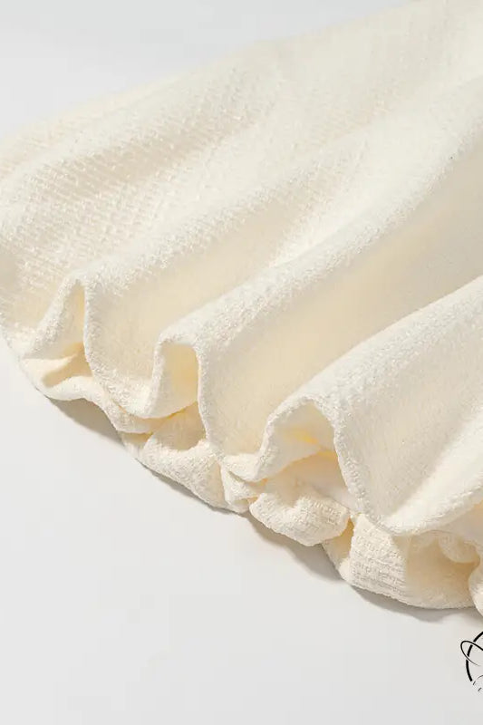 Enchanting short sleeve bud top with cream ruffled fabric skirt