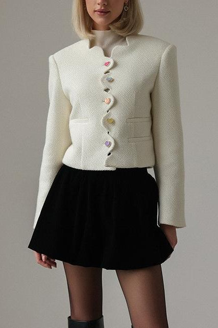 Langry fashion cream textured cropped jacket with white buttons and black skirt