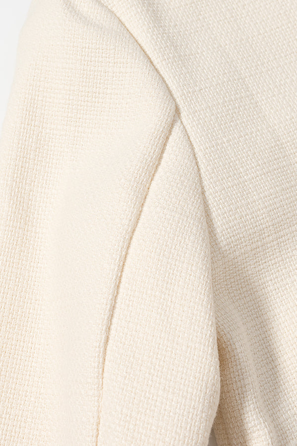 Cream-colored ribbed langry fashion sweater in classic short coat style