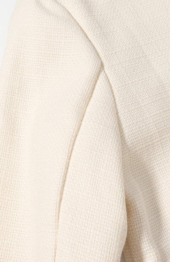 Cream-colored ribbed langry fashion sweater in classic short coat style