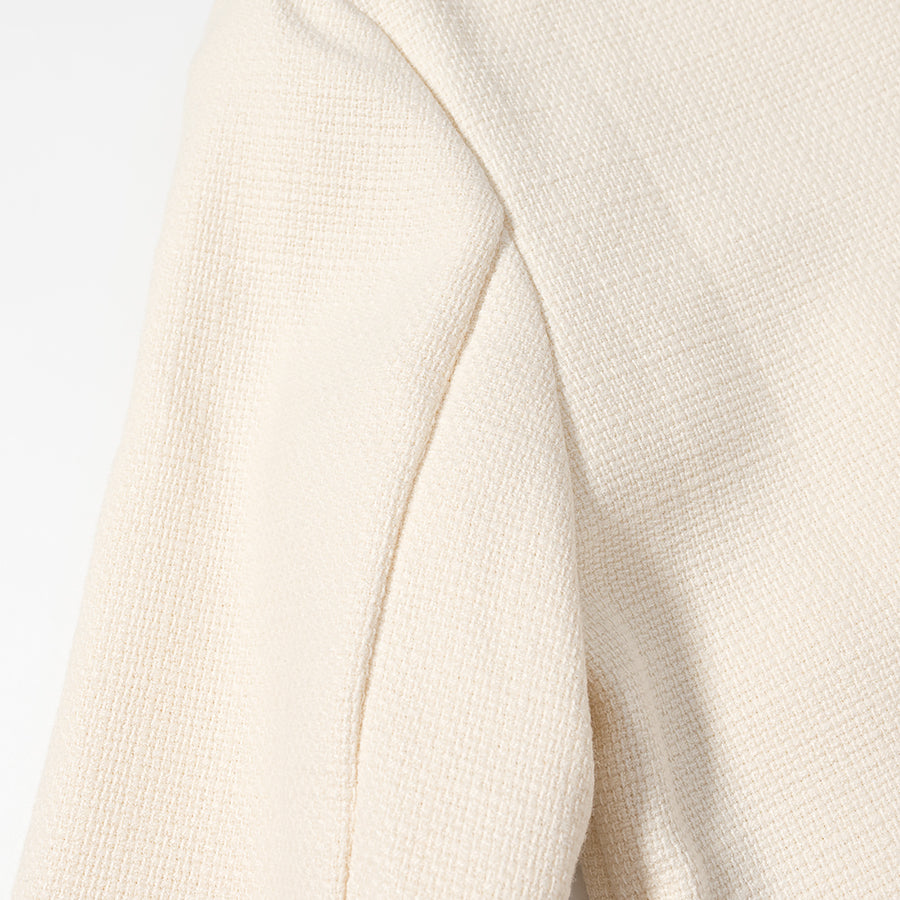 Cream-colored ribbed langry fashion sweater in classic short coat style