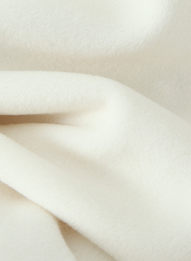 Elegant white silk scarf with soft folds on Langry fashion woolen jacket