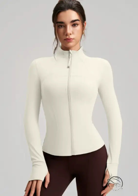 Long sleeve cream zip-up yoga jacket with ribbed cuffs and stretchy fabric
