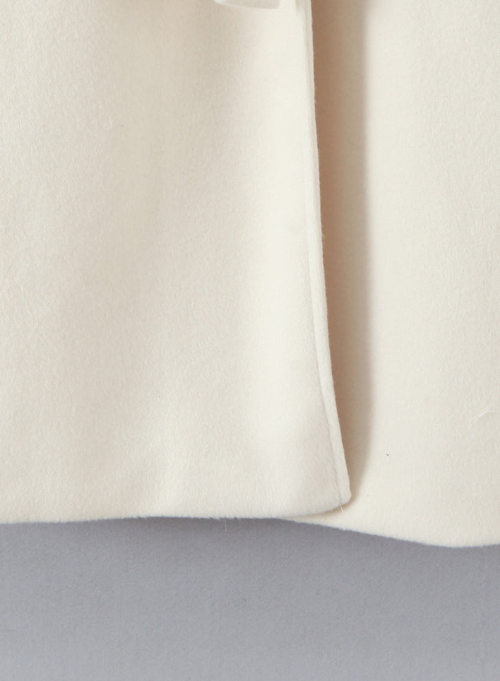 Elegant langry fashion cream cashmere scarf on white wool coat