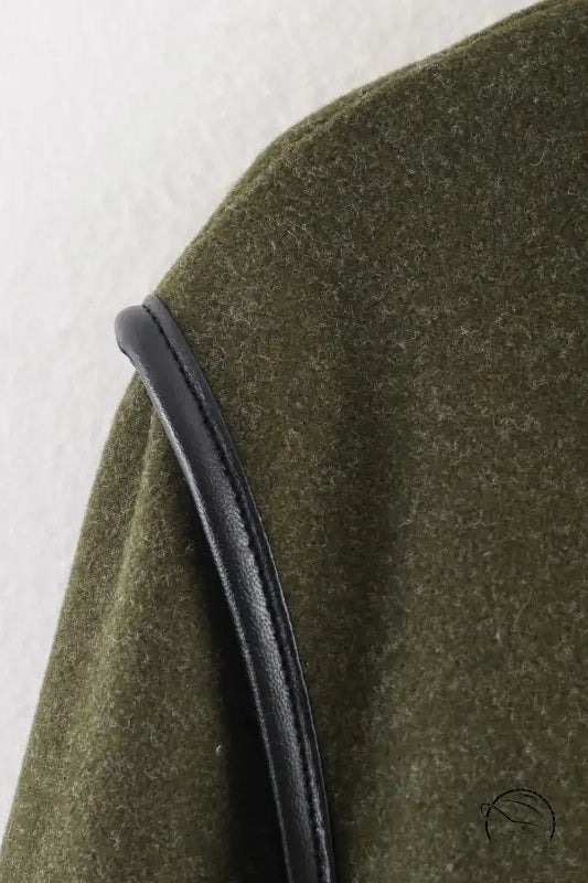 Olive green textured fabric with black leather strap on langry fashion coat