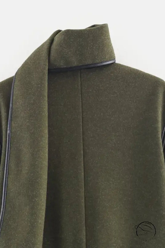 Olive green langry wool coat with black trim and high collar for cozy fashion