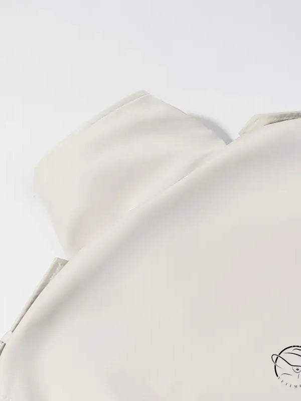 Cream-colored silk blouse in windbreaker winter fashion style