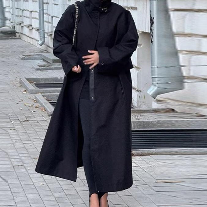 Fashionable black long trench coat with oversized sleeves and zipper details