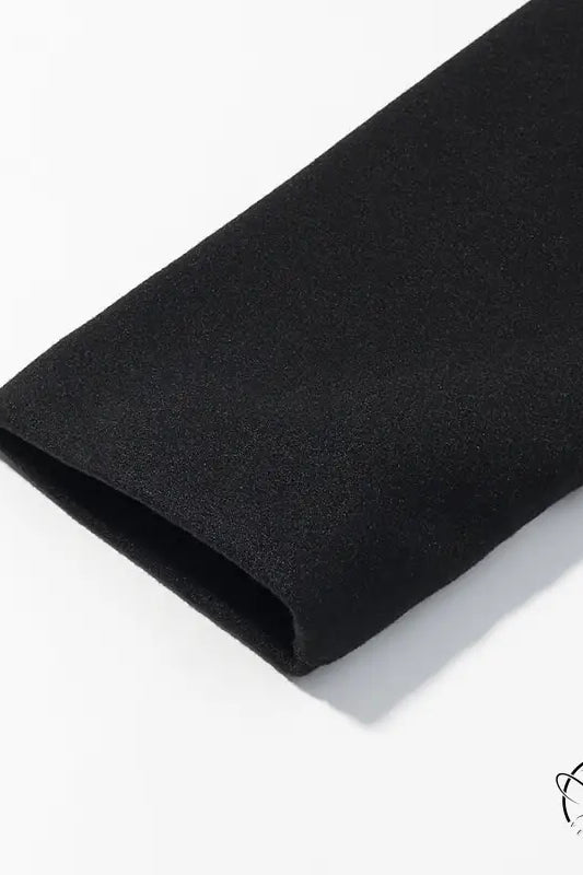 Black textured fabric wristband on elegant woolen coat