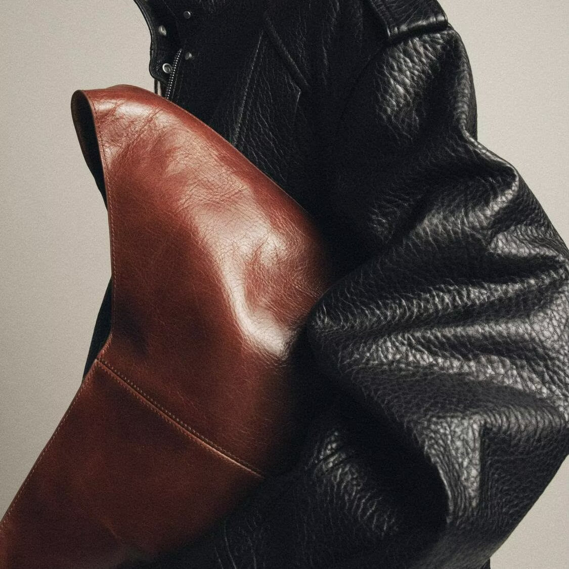 Elegant Langry faux leather bomber jacket with brown clutch bag