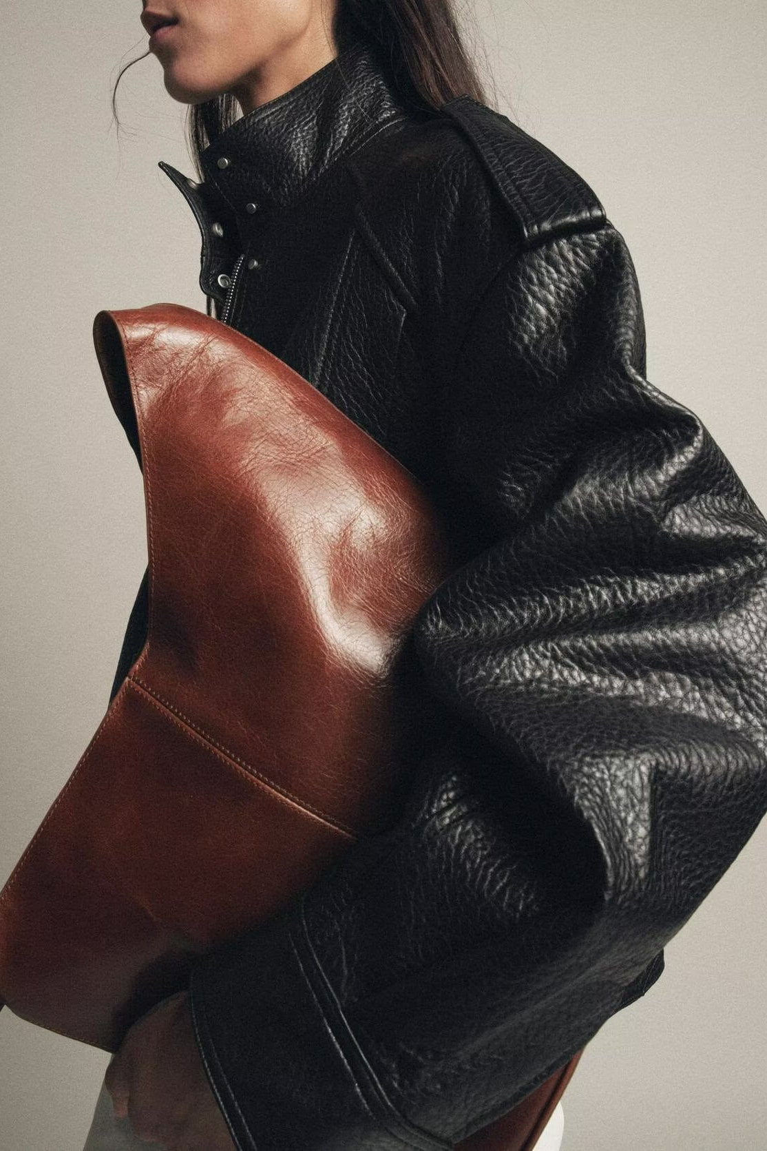 Elegant Langry faux leather bomber jacket with brown clutch bag