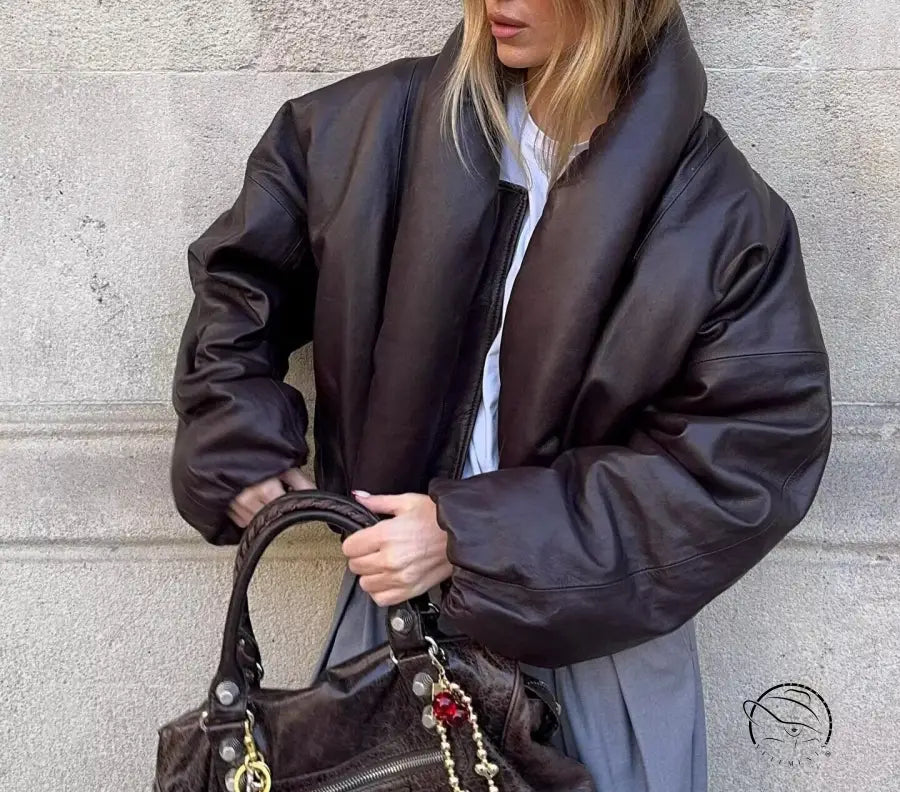 Fashion brown leather handbag with gold hardware and red tassel detail