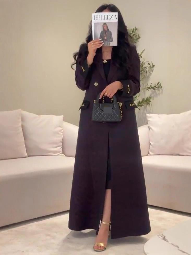 Black quilted handbag with gold-tone chain strap in Langry fashion trench coat