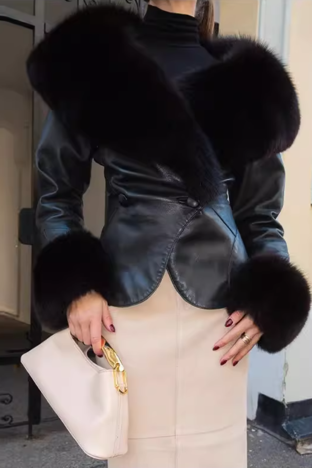 Langry fashion black leather fur-trimmed jacket with gold hardware and cream skirt