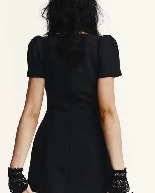 Enchanting short pleated pocket dress with black short sleeves, puffed shoulders, and lace gloves