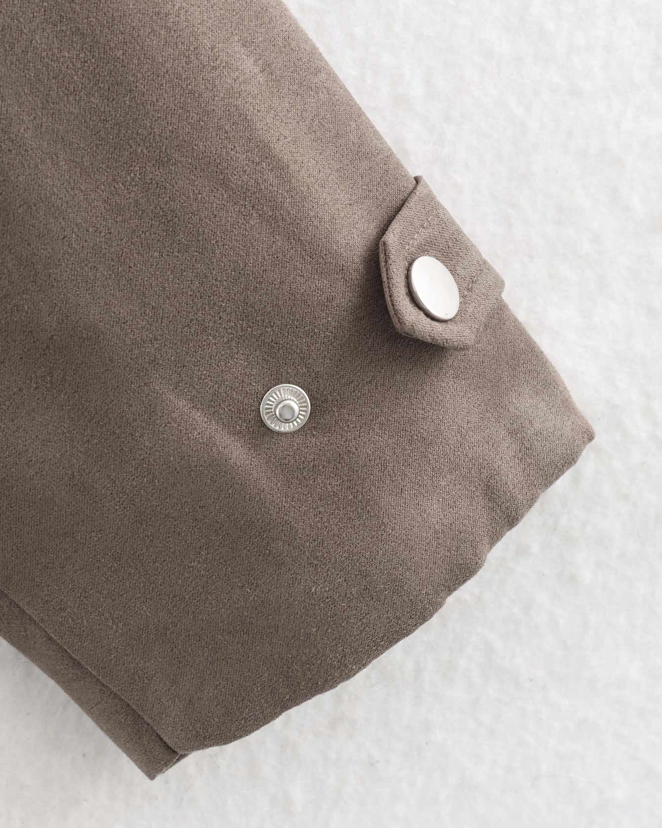 Brown suede jacket cuff with silver snap button in Warm & Cozy fashion