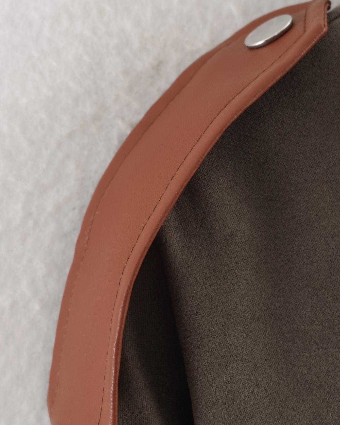 Tan leather strap with silver snap in Langry fashion suede jacket