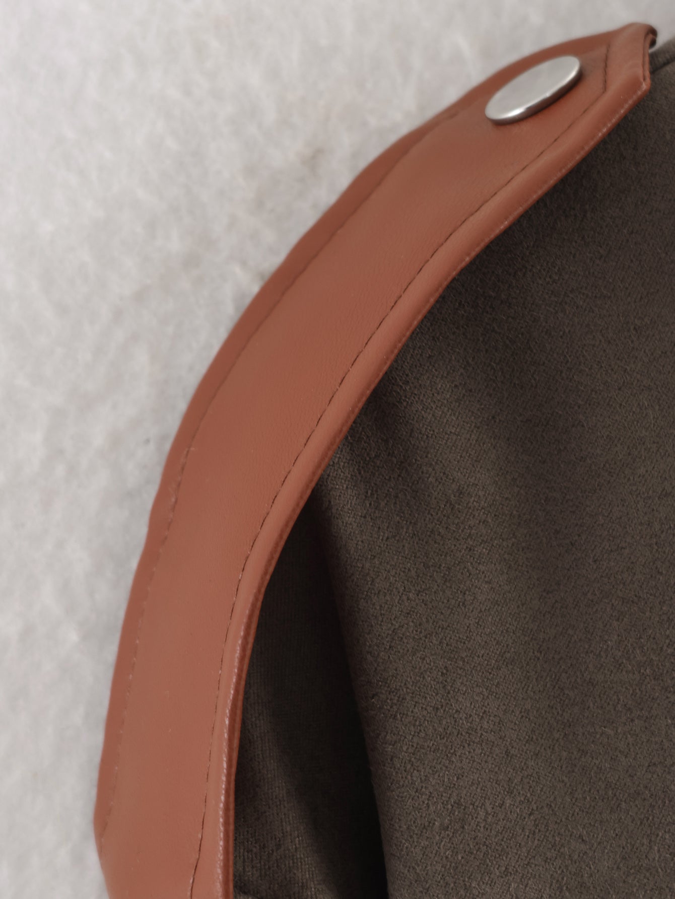 Tan leather strap with silver snap in Langry fashion suede jacket