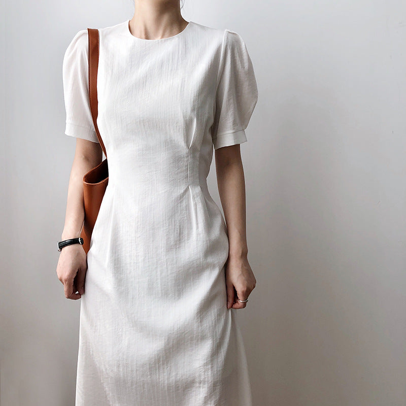 White linen midi dress showcasing French elegant puff sleeve design for sophisticated style