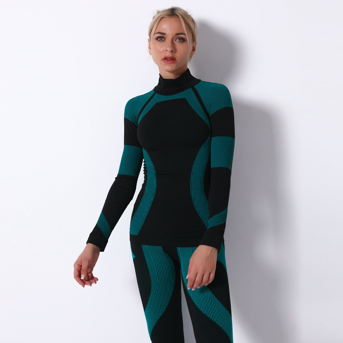 Black and teal seamless knitted turtleneck yoga top in neoprene geometric pattern