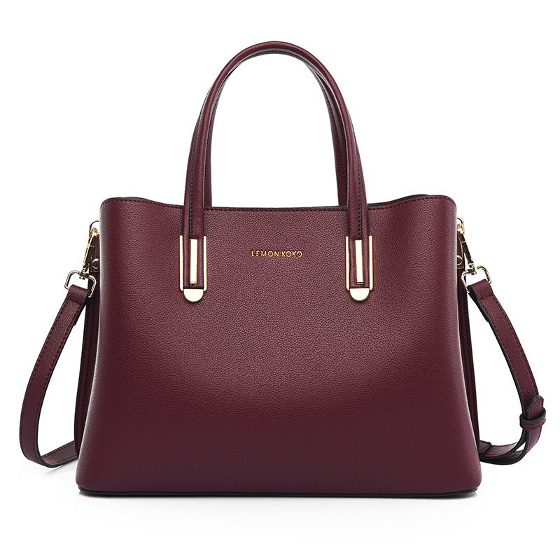 Burgundy leather handbag with gold hardware, stylish for fashion and ملابس