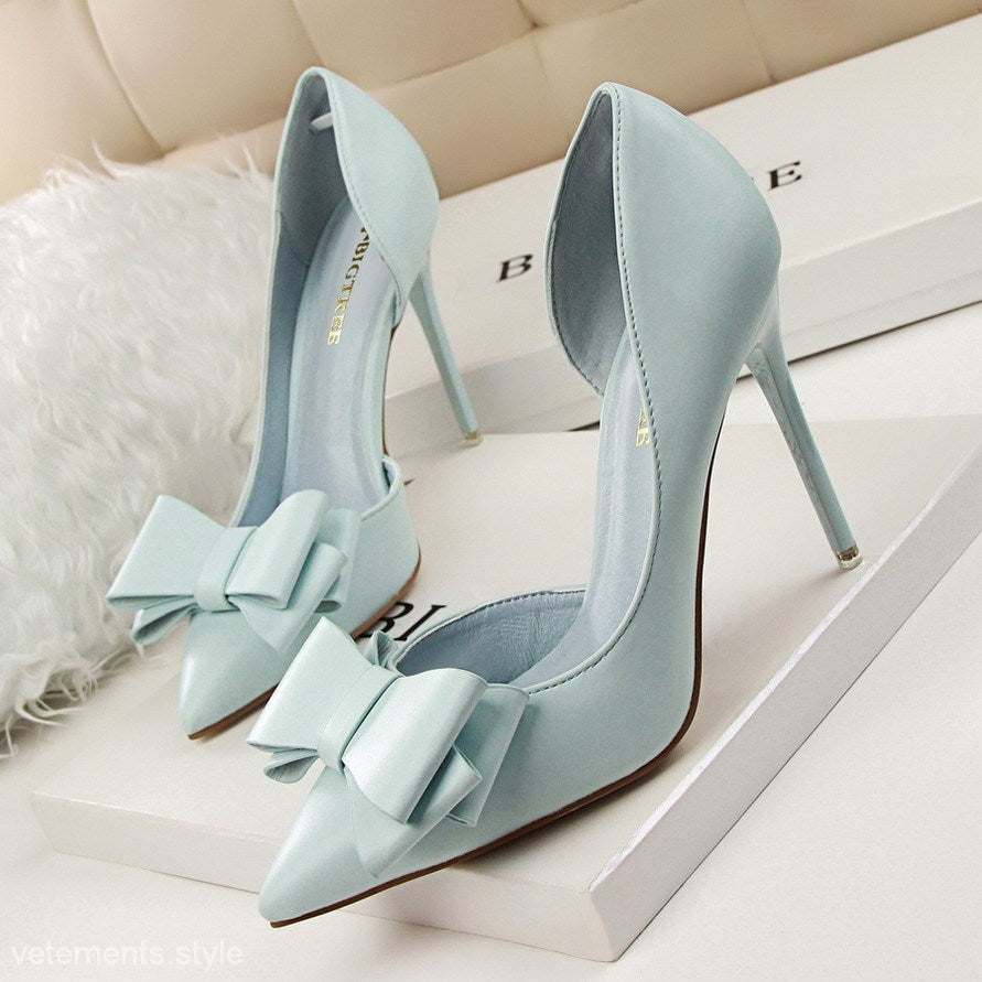 Pale blue high heels with decorative bows embody the perfect blend of elegance and style