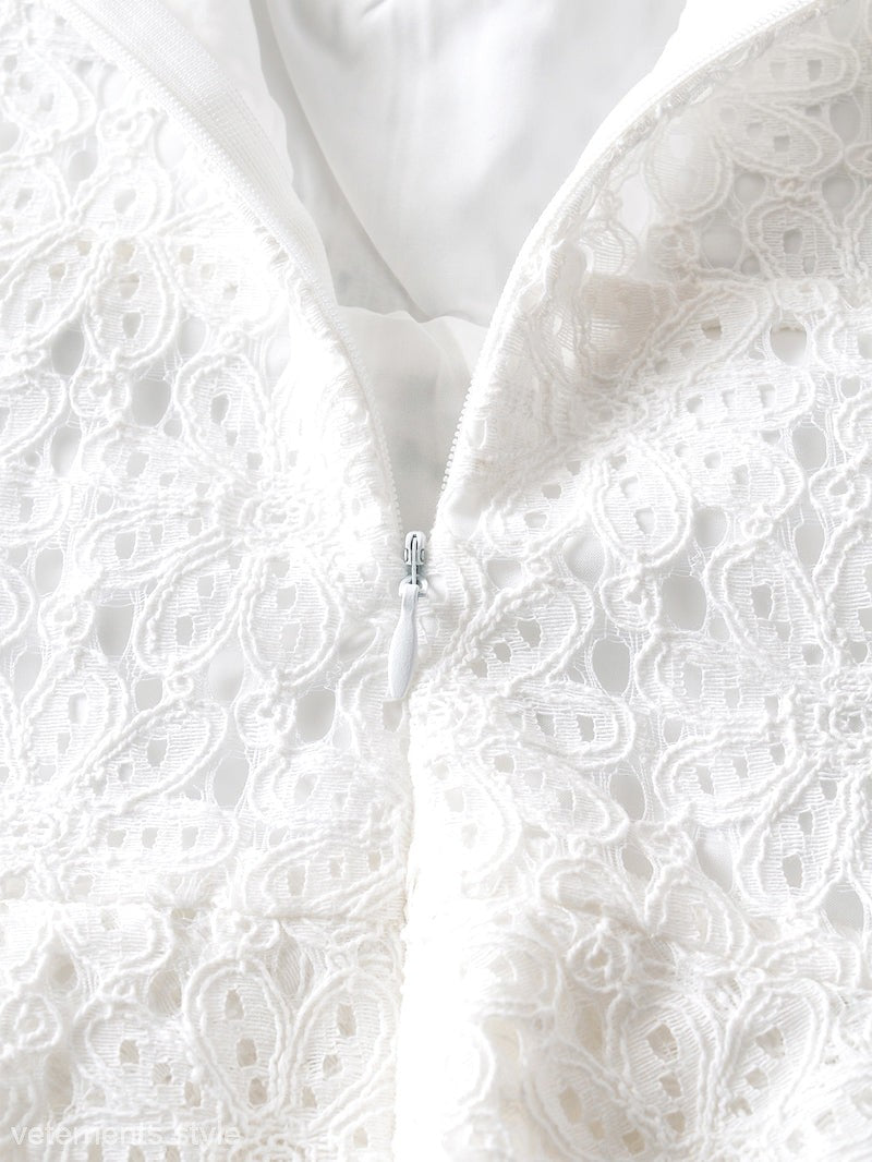 Elegant short lace dress featuring a zipper and intricate white lace detailing