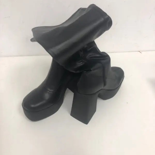 Classic black knee-high boots with chunky heels and platform design for a fashionable look