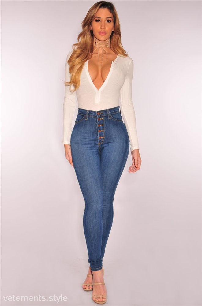Woman wearing a white bodysuit and high-waisted jeans in Skinny Denim Blue Casual style