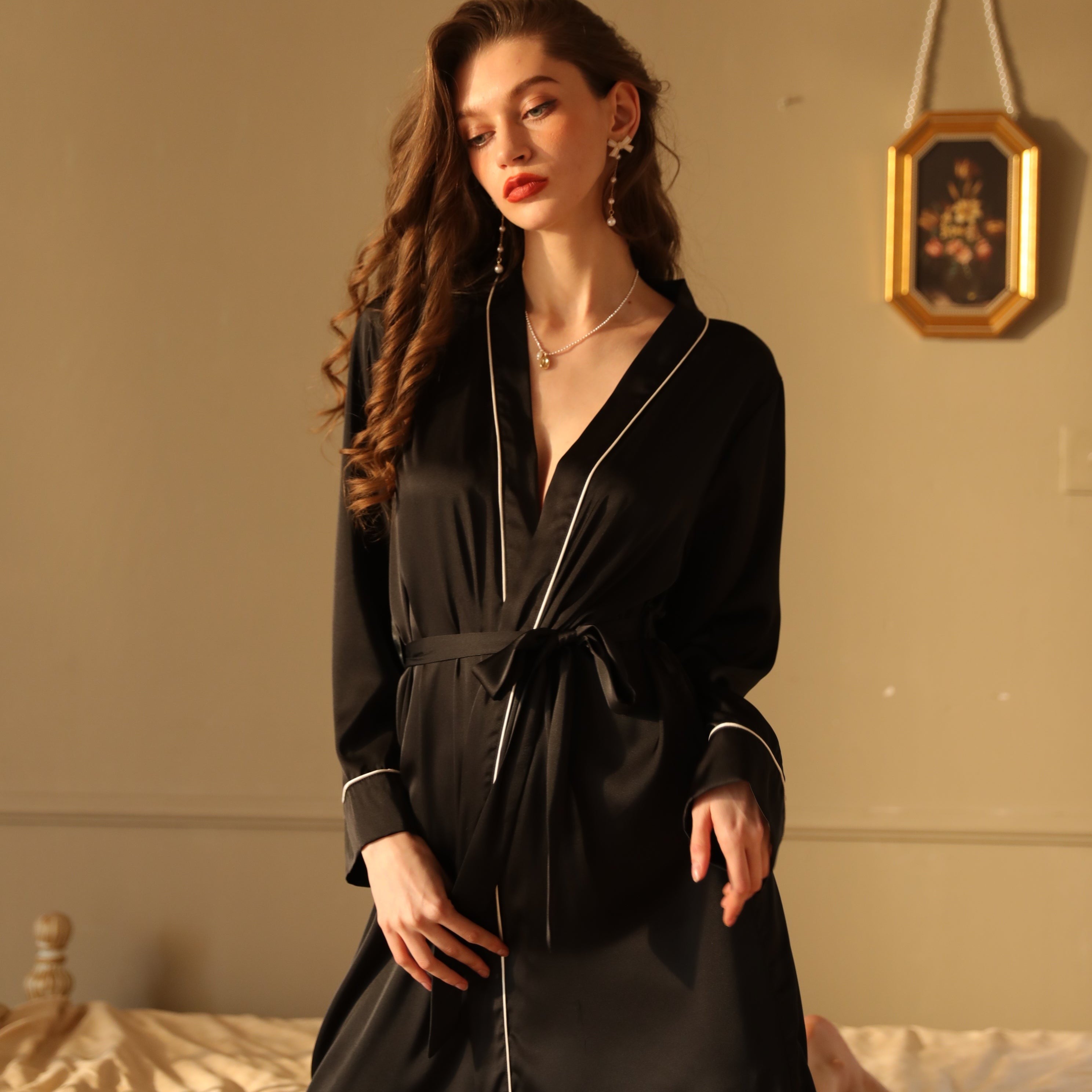Elegant silk night-robe with black satin fabric and white piping, perfect for luxurious outerwear gown