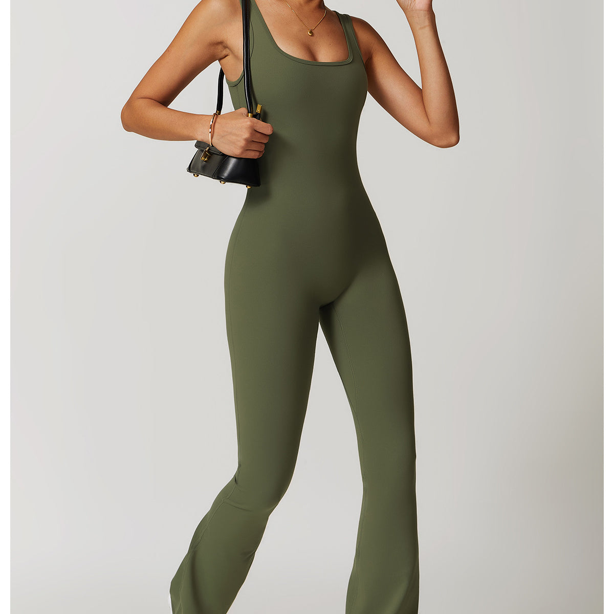 Olive green sleeveless jumpsuit with flared legs and white sneakers for stylish langry fashion
