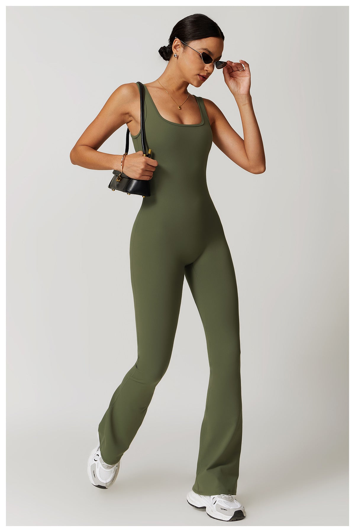 Olive green sleeveless jumpsuit with flared legs and white sneakers for stylish langry fashion