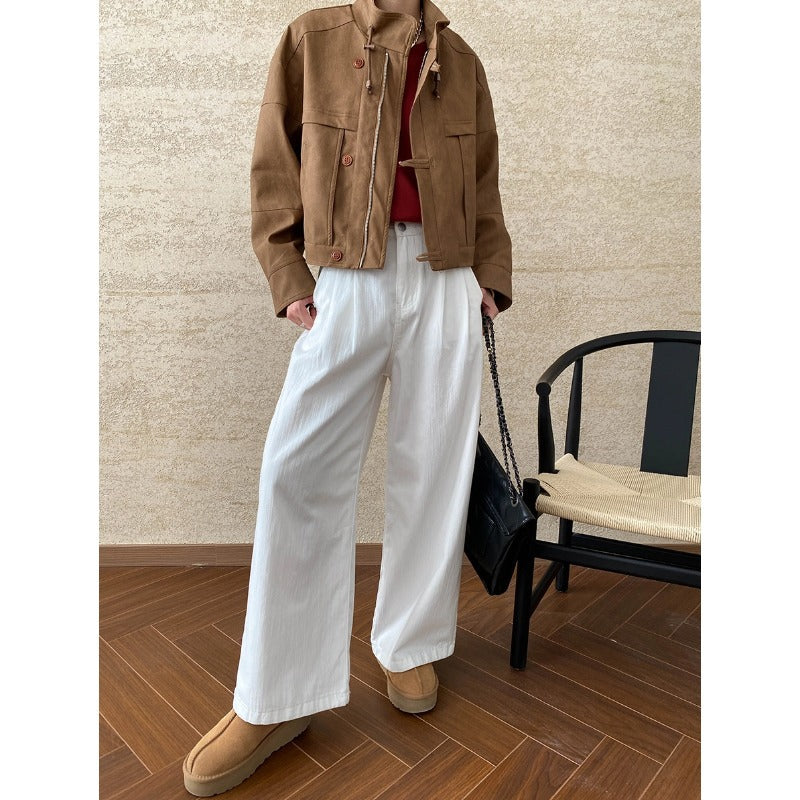 Woman wearing a high-quality casual leather coat with brown jacket and white pants for fashion