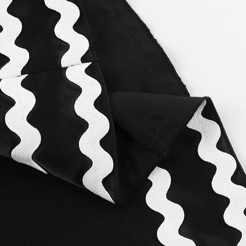 Black fabric with white wavy trim on elegant backless line dress for summer fashion