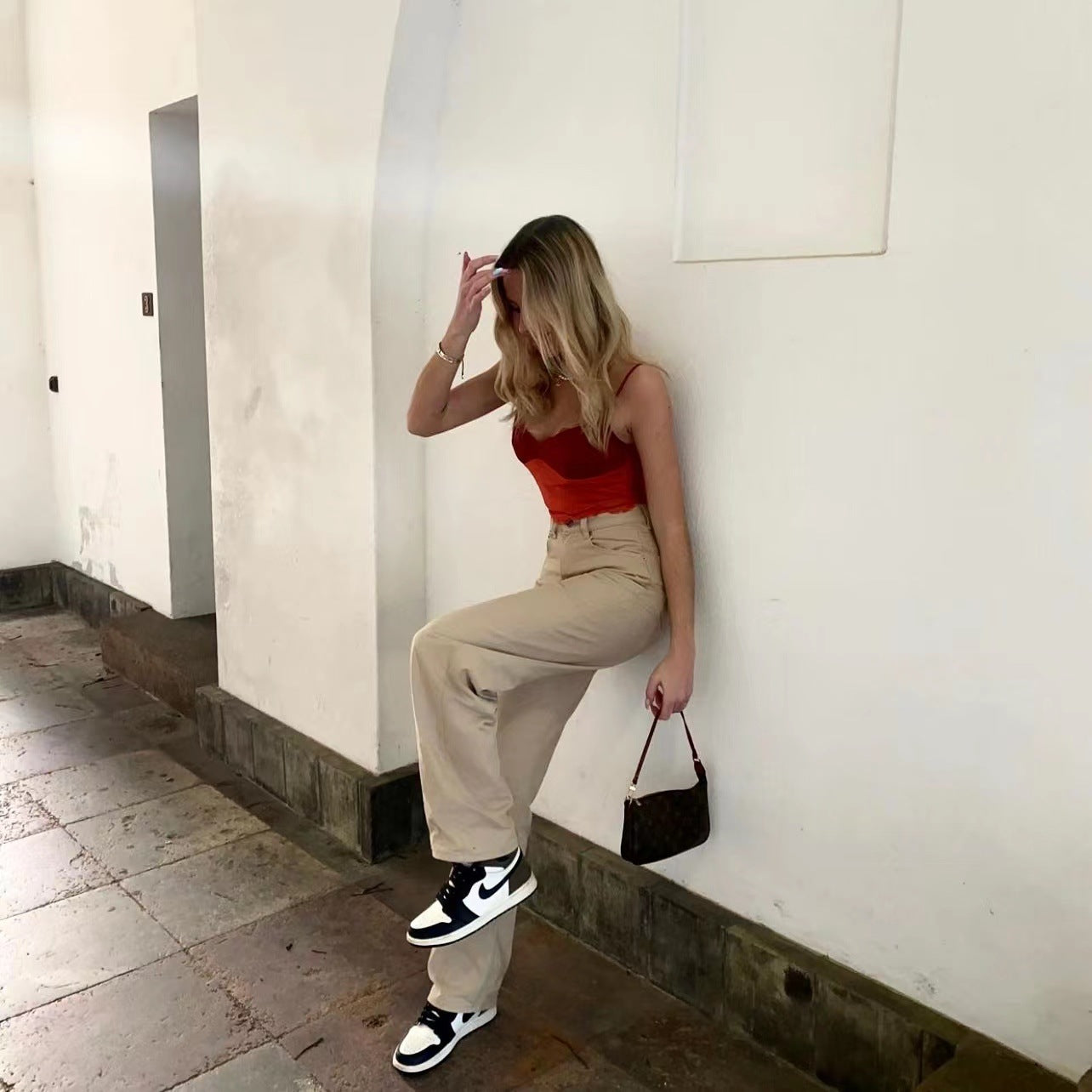 Woman in red top and beige trousers showcasing Retro Light Khaki High Waist Draggle Tail Jeans fashion