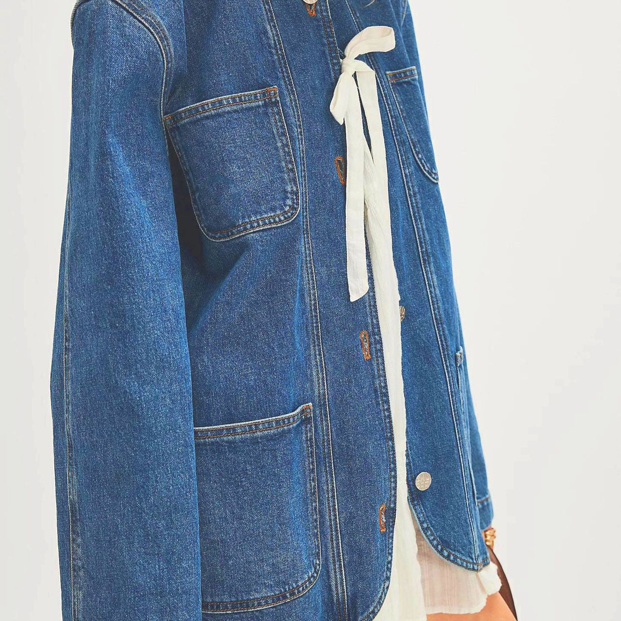 Blue denim casual fashionable cowboy coat with round neck, white ribbon closure, and patch pockets