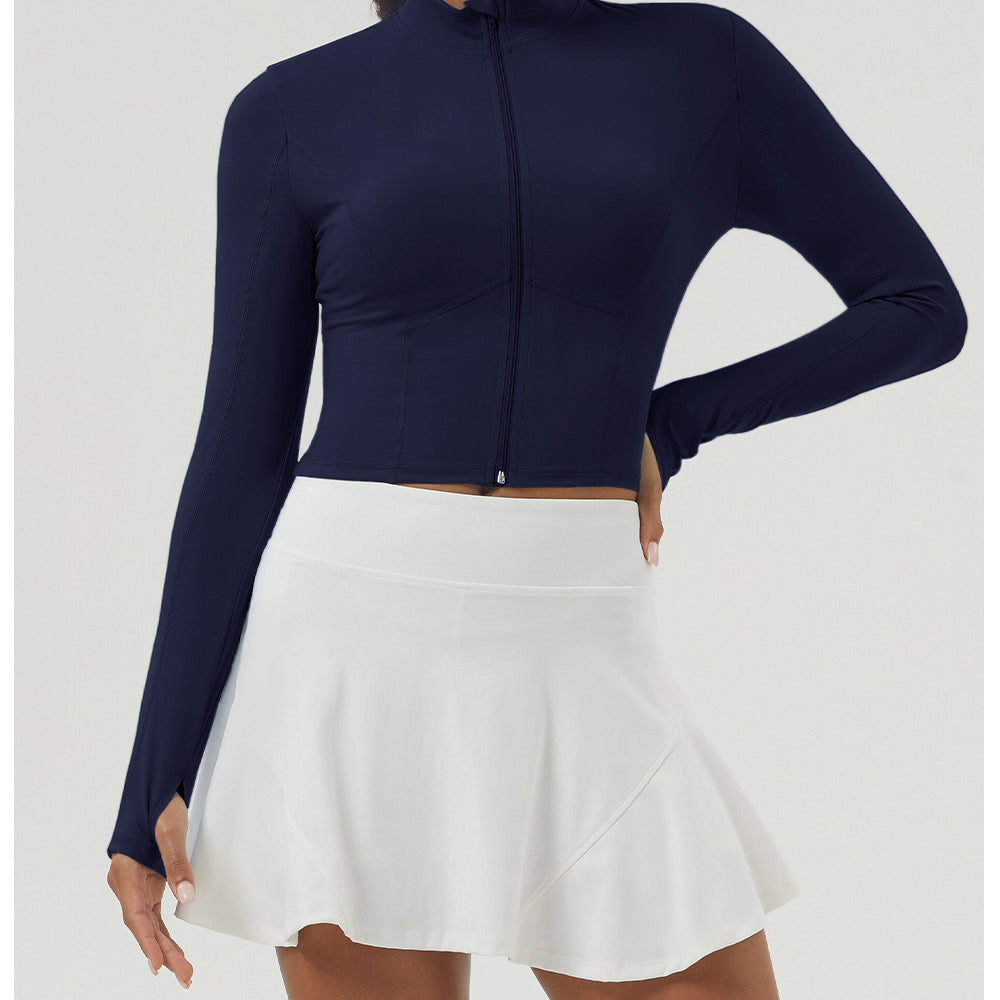 Long sleeve athletic top with front zipper worn with white tennis skirt, stylish sportswear for women