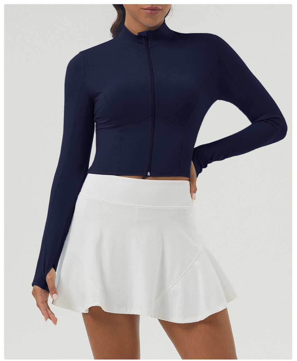 Long sleeve athletic top with front zipper worn with white tennis skirt, stylish sportswear for women