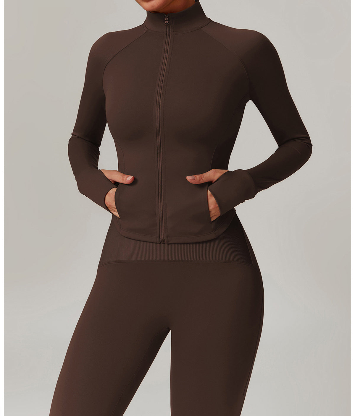 Brown athletic zip-up jumpsuit, ideal for yoga, featuring a fitted design and long sleeves