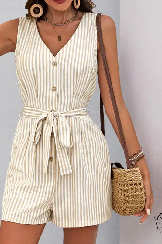 Beautiful summer jumpsuit: sleeveless beige and white striped romper with button front and waist tie