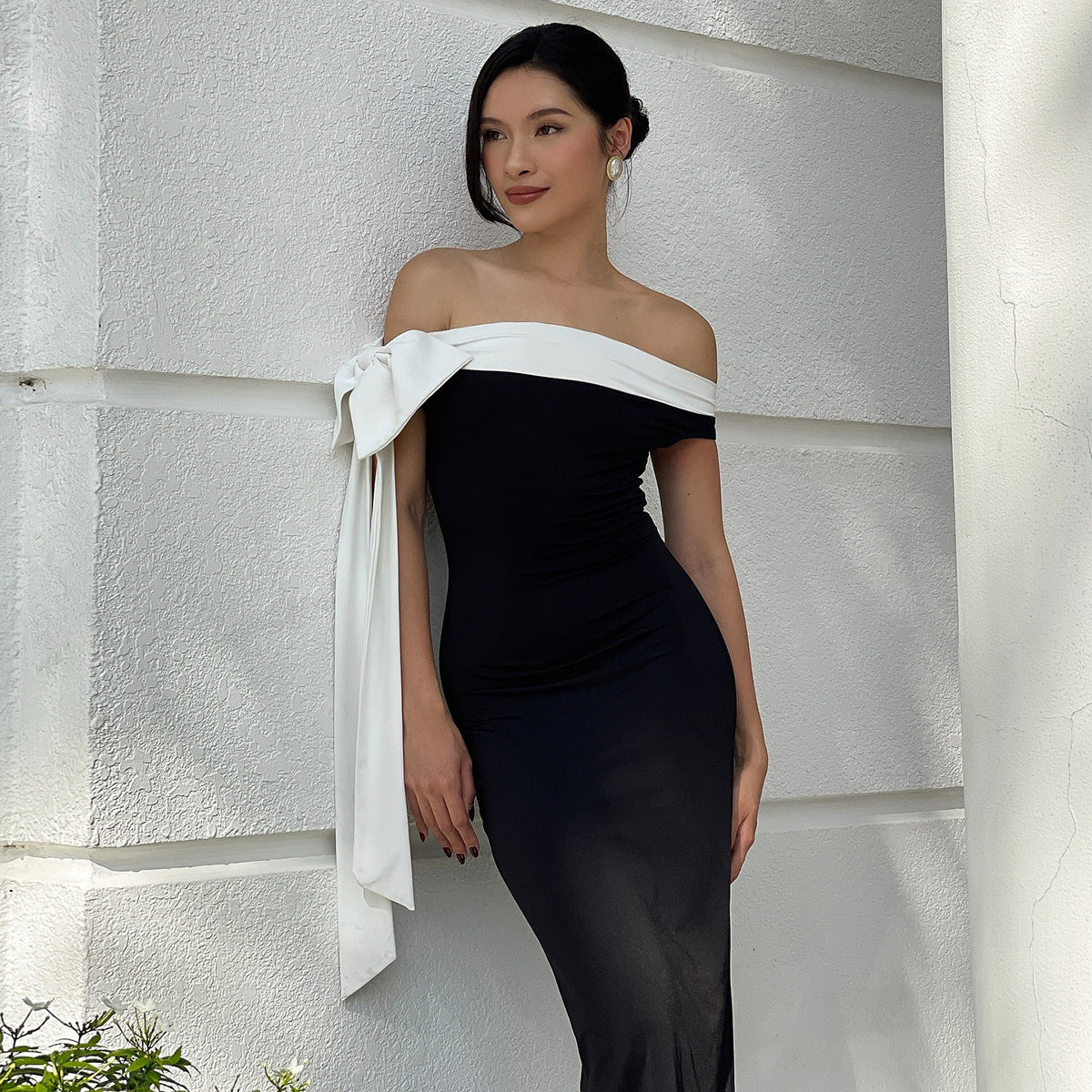 Elegant black and white off-shoulder gown with bow detail for fashionable slim dress