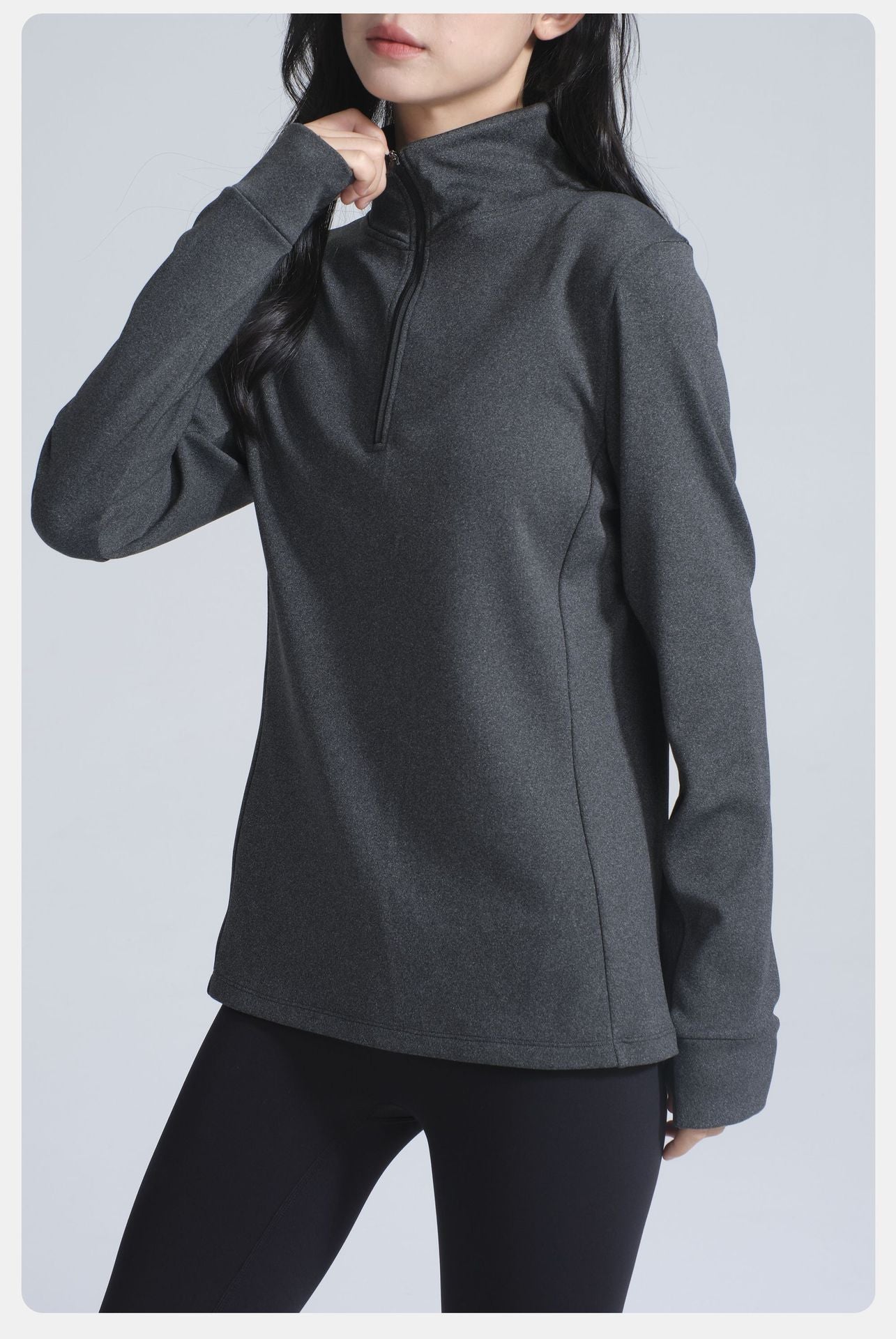 Dark gray long-sleeve athletic top with quarter-zip for winter thermal yoga fashion