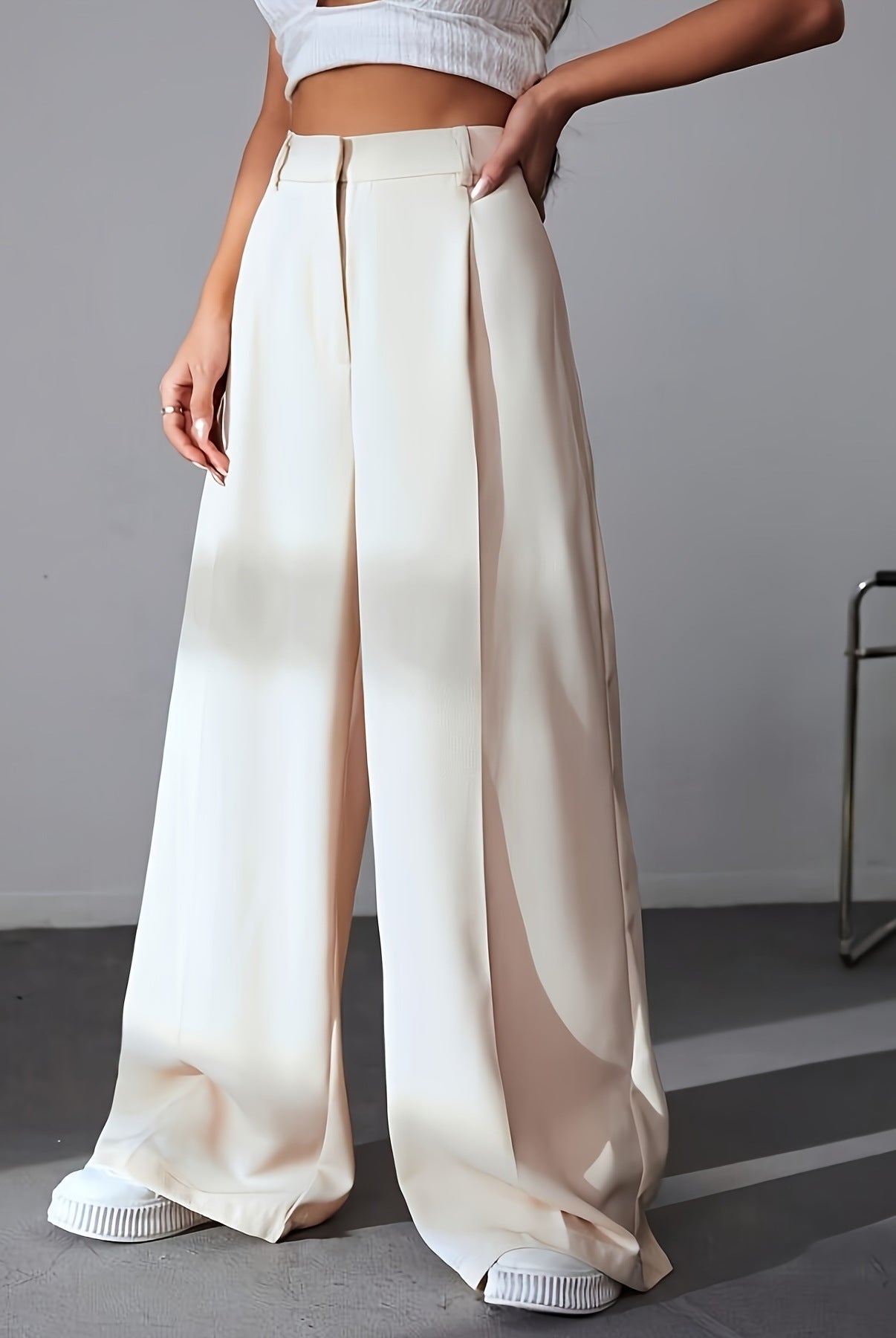 Cream-colored wide leg trousers showcasing high waist and elegant pleats for women’s fashion