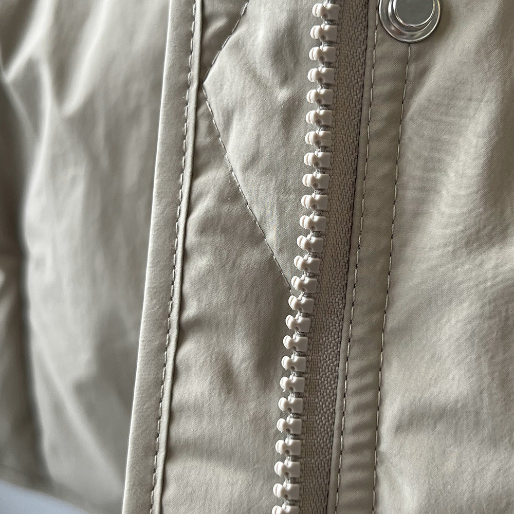White plastic zipper with stitching on light gray fabric of Winter Korean vest for fashion ملابس