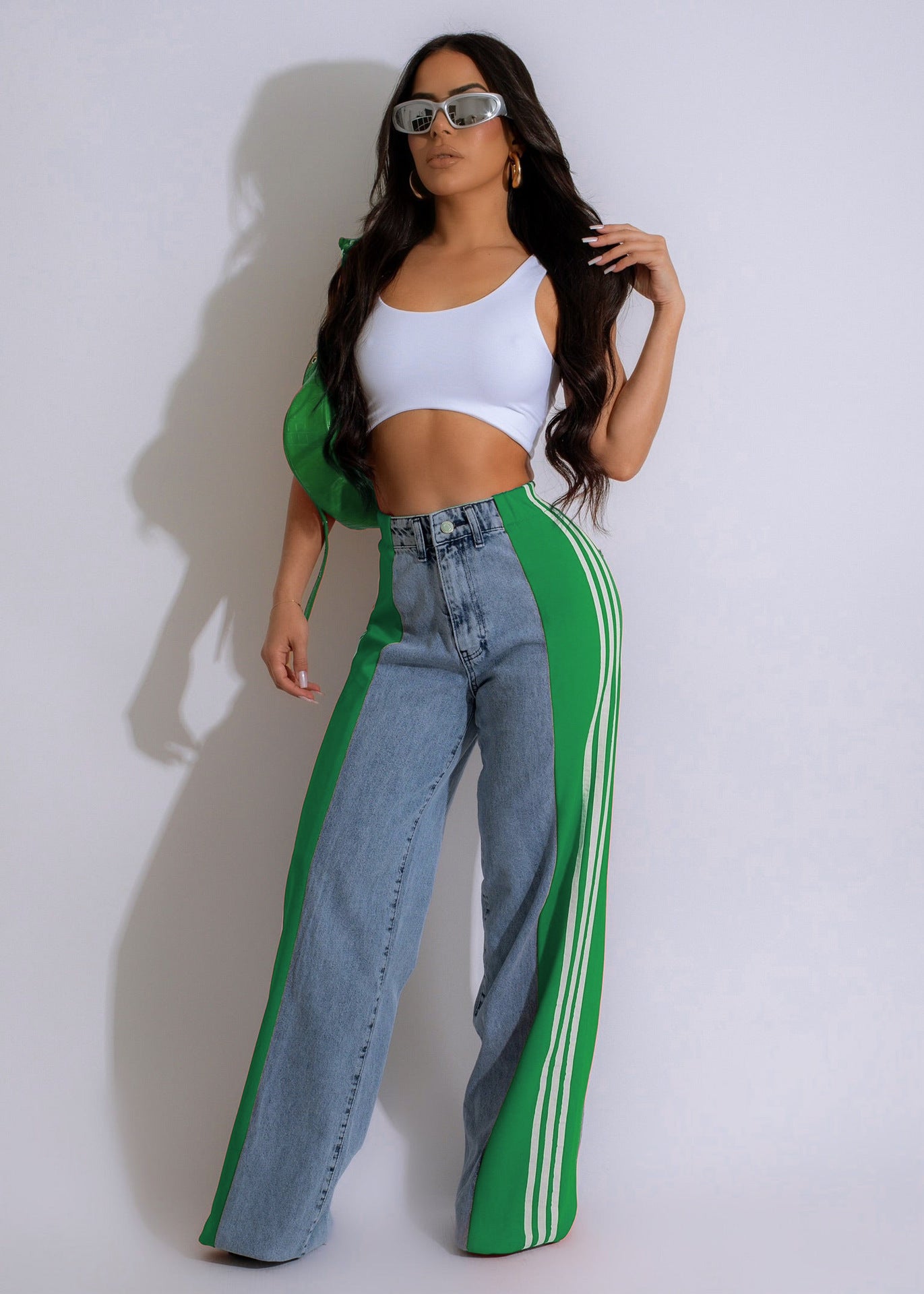 Customized denim jeans with green side panels and a white crop top for stylish casual wear