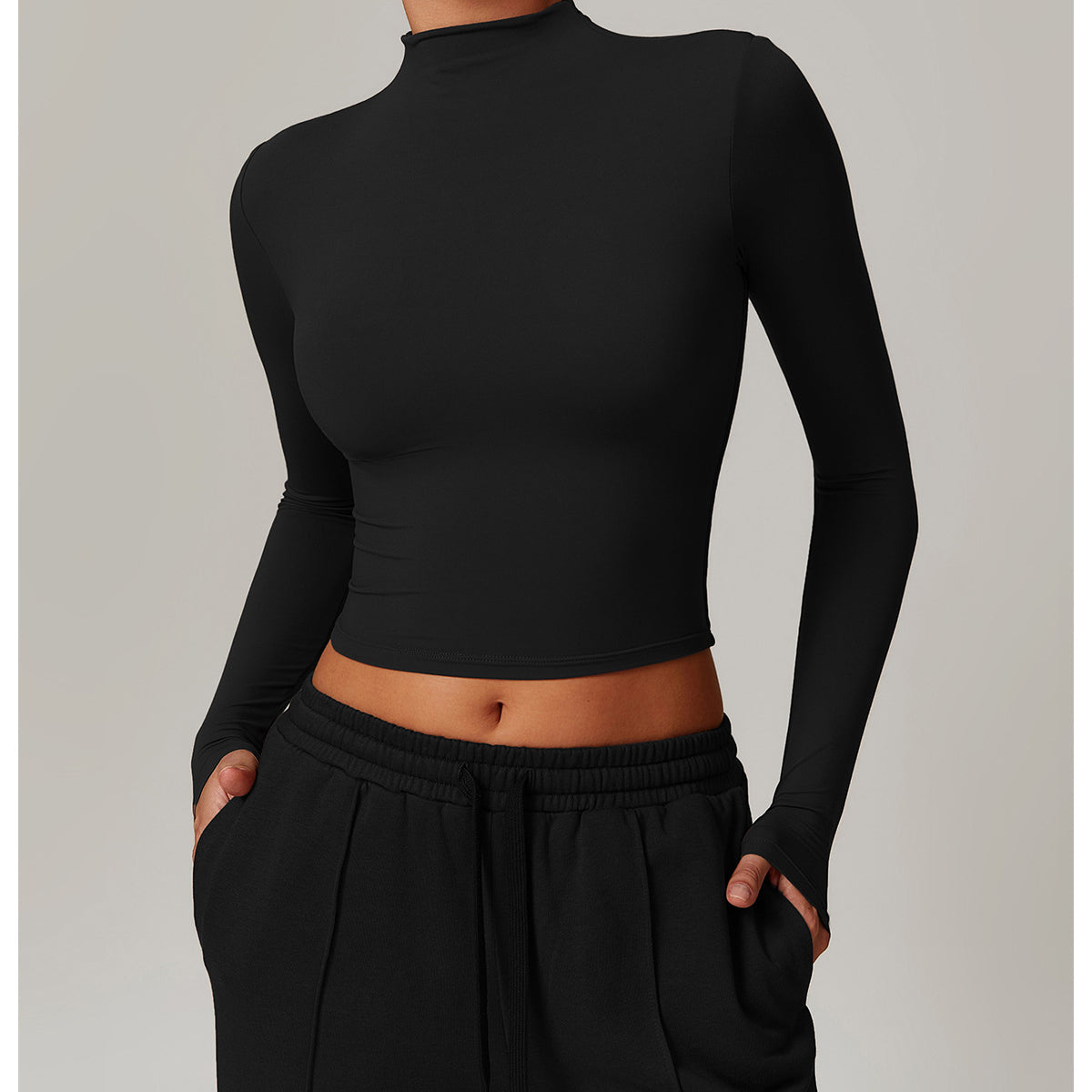 Black long-sleeved crop top with mock turtleneck for stylish langry fitness wear